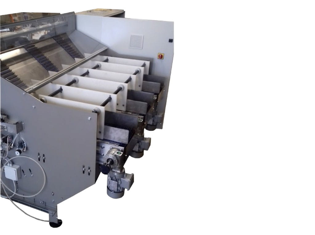 Dettaglio laterale di un caricatore automatico per grissini con focus sulle vasche di contenimento in materiale plastico alimentare e motoriduttori esterni.